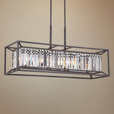 لوستر آویز خطی مستطیلی با فریم فلزی مشکی و کریستالهای شفاف روشن در پس زمینه دیوار آجری تیره.