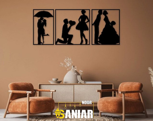 «ست سه تایی قاب فلزی مشکی با طرحهای سیلوئت عاشقانه (قرار زیر چتر، زانو زدن و عروسی)، نصب شده روی دیوار قهوهای روشن بالای یک کنسول مدرن».