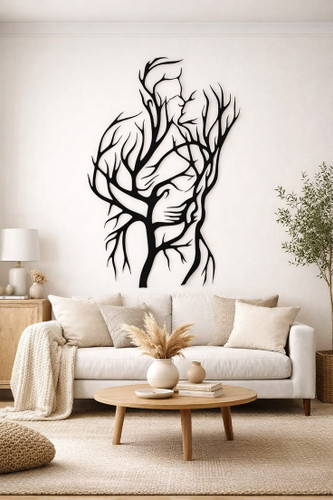 یک تابلو فلزی مشکی طرح لاینآرت که در هم تنیده شدن بدن انسان و شاخههای درخت را نشان میدهد و روی دیوار سفید یک نشیمن مدرن نصب شده است.»